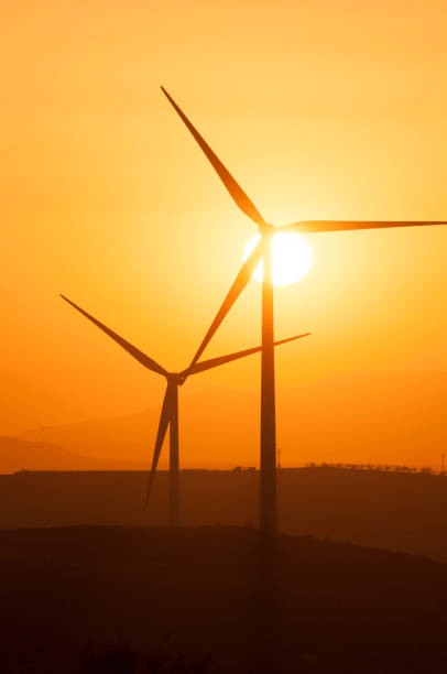istock sunset over a field of wind turbines 1326476250