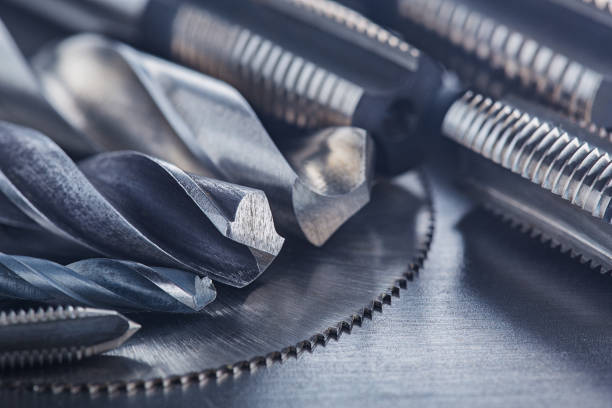 istock set of different drill bits,thread tap and mill cutters on steel plate background. Locksmithing deal. 1326478140