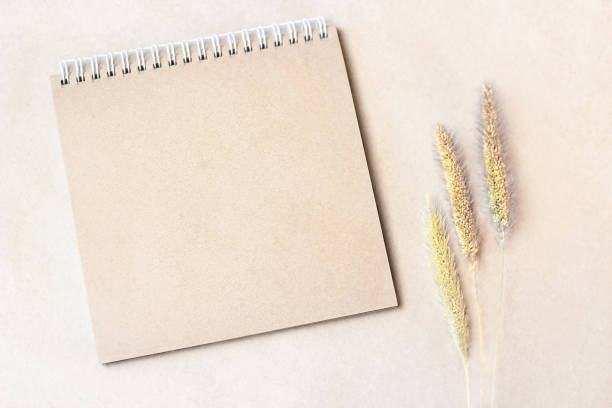 istock the craft notebook lies on a brown table with dry spikelet. 1326478953