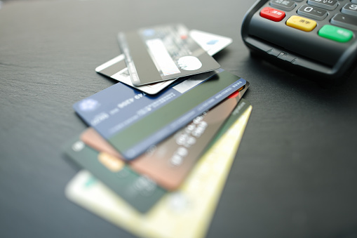Stacking credit cards and credit card machines on the counter desktop