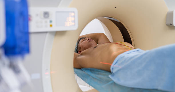 istock Doctor Preparing Patient For Examination In MRI Scan Tunnel 1326480219