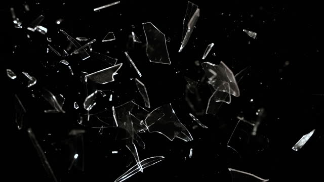 Studio Full-Frame Wide Plate Shot of Real Window Glass Pane Shattering and Breaking on Black Background