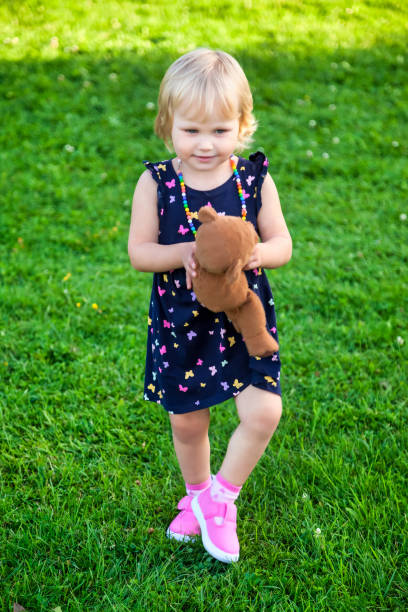 istock Blond Toddler Playing with Teddy Bear 1326480346