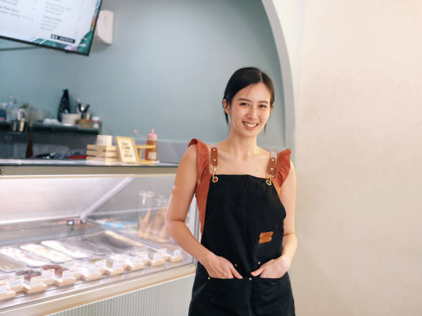 istock waitress in front of ice cream parlour 1326482363