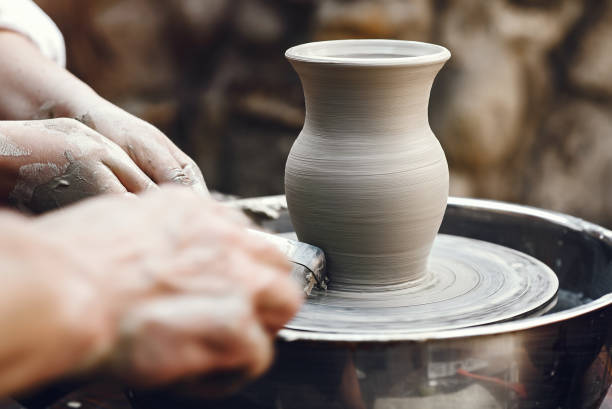 istock People making a vaze from a clay on a pottery's machine 1326482502
