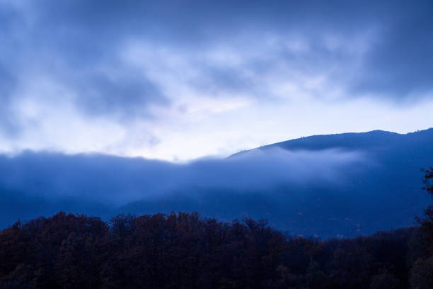 istock Mountains in the clouds against the blue twilight sky 1326482565