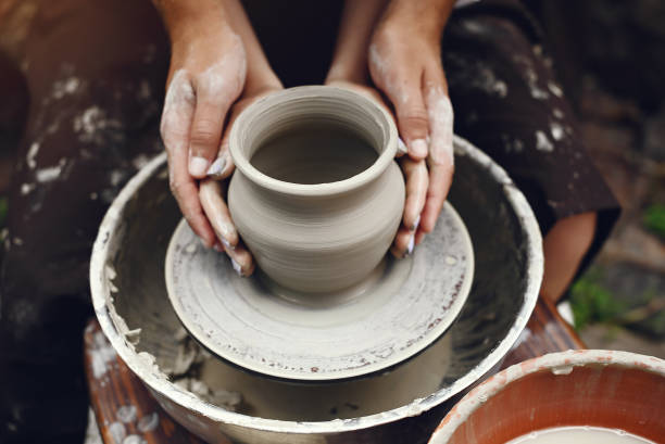 istock People making a vaze from a clay on a pottery's machine 1326482585