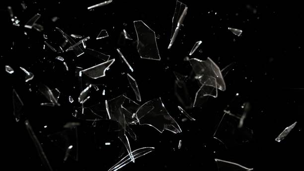 studio full-frame wide plate shot of real window glass pane shattering and breaking on black background - shot glass glass black empty photos et images de collection