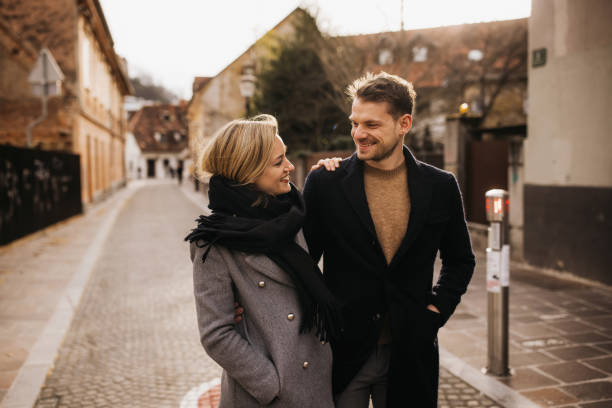istock Happy cute couple walking down a historical street 1326487676