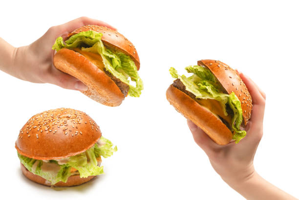 istock Hamburger in woman hands isolated on a white background. 1326488289