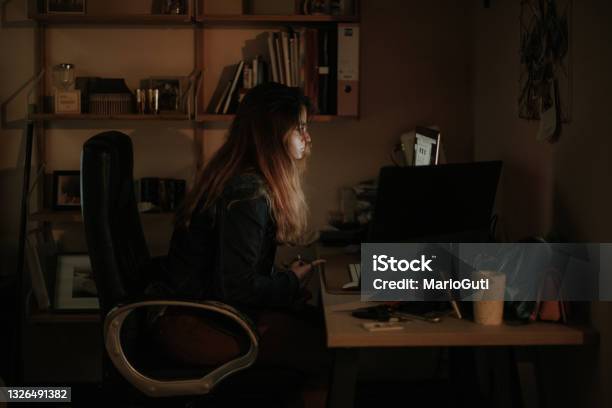 Young Woman Using Computers In A Dark Room Stock Photo - Download Image Now - Darkroom, Laptop, Computer