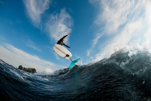 istock wonderful view of foilboard on which man effectively jumping on the wave 1326494634