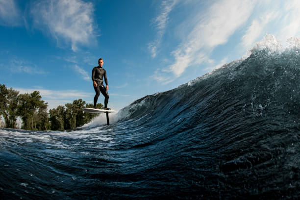 istock active man riding on the wave with hydrofoil foilboard 1326494749