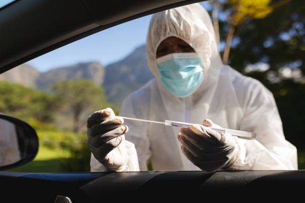 istock Medical worker wearing ppe suit taking swab test 1326495759