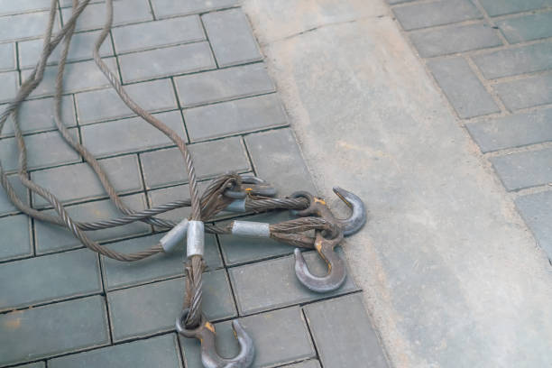 istock Four hooks with steel cables lie on the sidewalk with copy space 1326496020