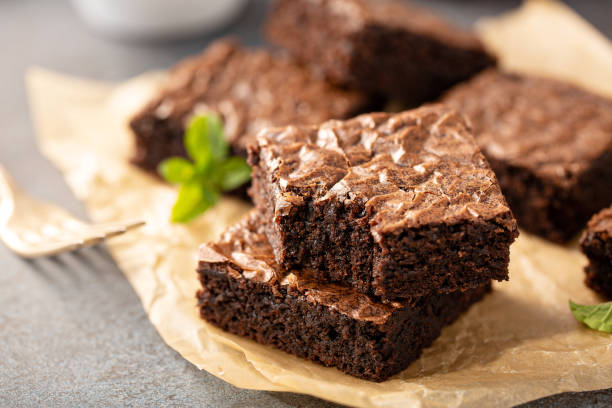 istock Freshly baked brownies on a parchment paper 1326497433