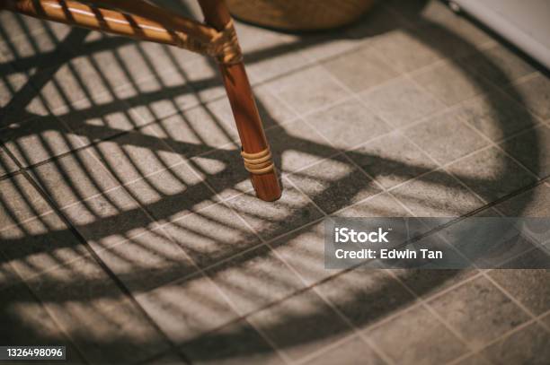 Shadow Of Rattan Chair On Tile Floor With High Angle View Stock Photo - Download Image Now