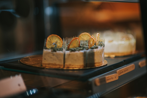 slices of cheese cake in refrigerator displayed in bakery shop café coffee shop