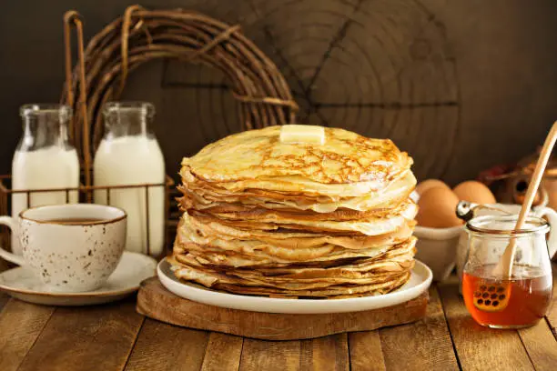 Stack of thin russian pancakes or crepes made for shrove Tuesday or Maslenitza, spring celebration