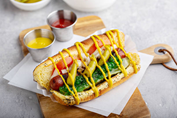 Chicago hot dog on a poppy seed bun Chicago hot dog on a poppy seed bun topped with tomatoes and sweet relish hot dog photos stock pictures, royalty-free photos & images