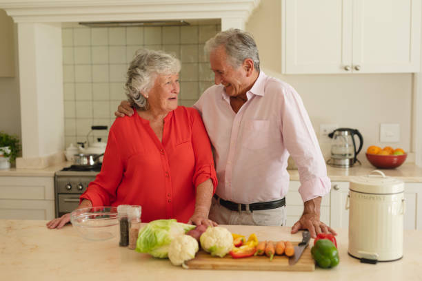 istock Senior caucasian couple embracing and smiling in kitchen 1326501274