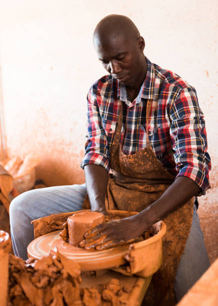 istock Man making ceramics on pottery wheel 1326502169