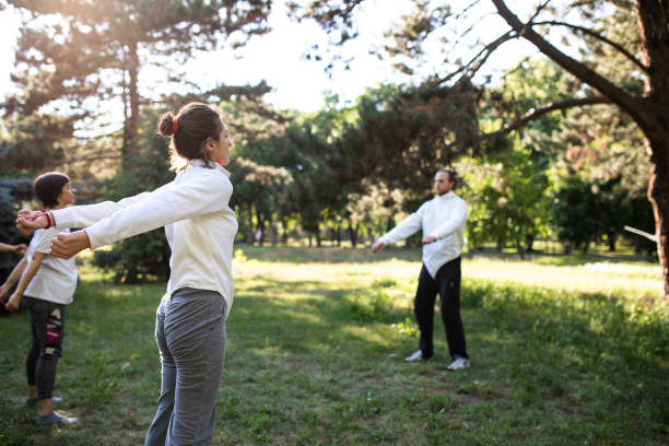 istock Young adults exercising in a park 1326503335