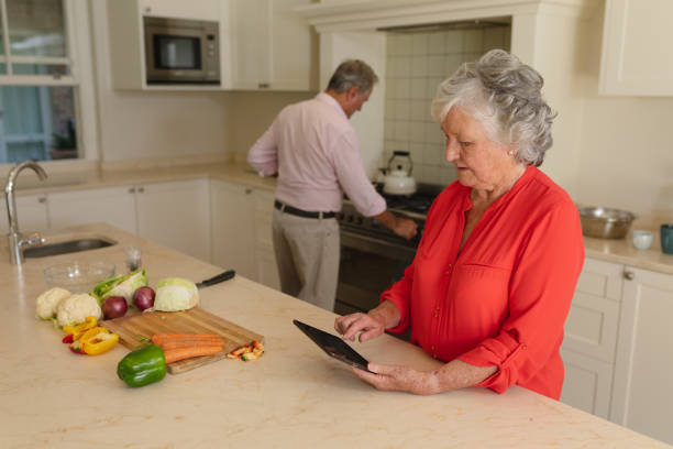 istock Senior caucasian couple cooking together and using tablet in kitchen 1326503530