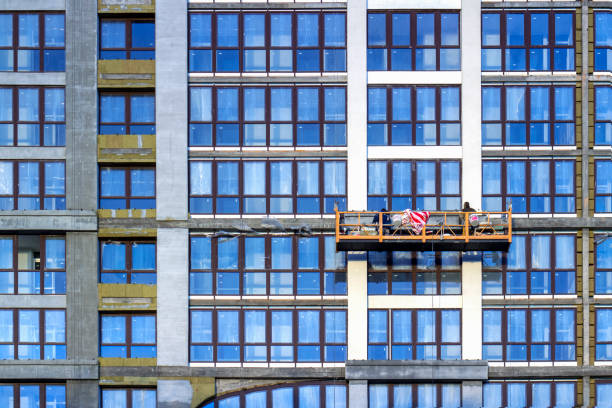 istock two builders in construction cradle works on a building 1326503568
