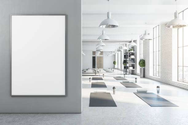 Modern bright white yoga studio gym interior with empty poster, window and city view. Mock up, 3D Rendering.