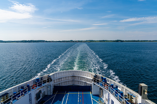 view of the open ocean with the wake of a large passenger ferry