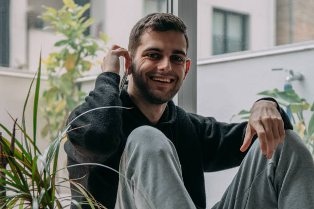 istock young man with mobile phone at home 1326505465
