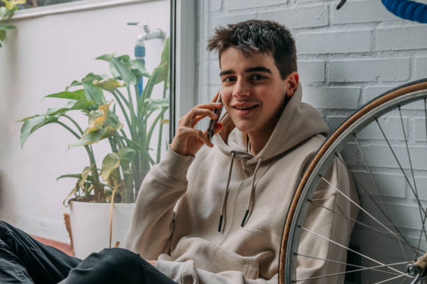 istock young man with mobile phone at home 1326505505