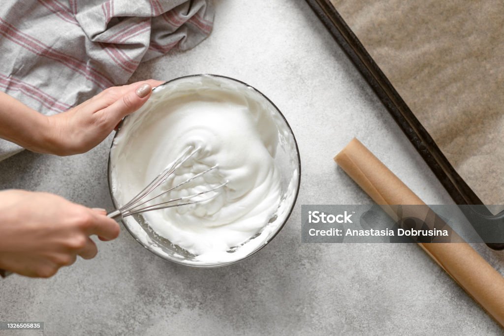 Process of making french meringue. Whipped eggs. Whipped egg whites. Step by step recipe of Pavlova cake. Baking concept. Top view. Cream - Dairy Product Stock Photo