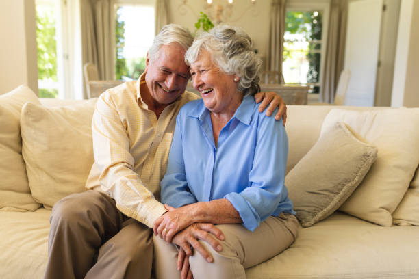 istock Senior caucasian couple sitting on sofa holding hands 1326507670