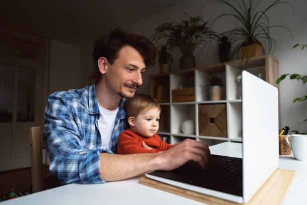 istock Young father working at home with his baby boy 1326507751