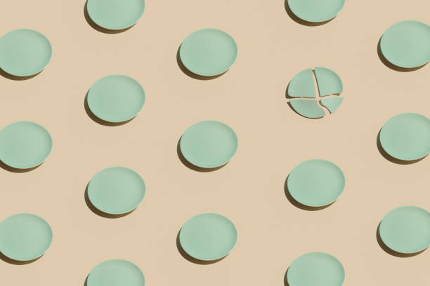 istock Minimalistic irregular pattern arrangement with mint green plates against pastel beige background. Creative diet or eating idea, aesthetic broken concept. 1326510578