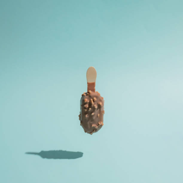 istock Creative summer refreshment idea with isolated ice cream or popsicle turned upside down on bright blue background. Aesthetic sweet food and holiday concept, minimalistic square composition. 1326510583