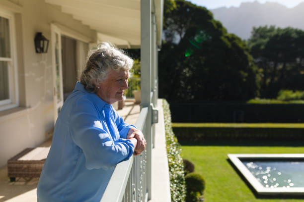 istock Senior caucasian woman standing on balcony and looking away 1326510708