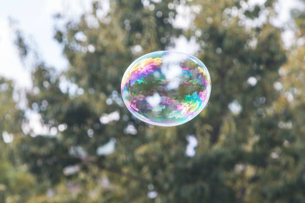 istock Large Colorful Soapy Bubble Floats Through Air At Festival 1326513446