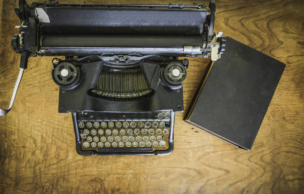 istock antique black typewriter on a mahogany wood desk viewed from above 1326513456