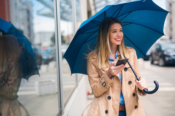 istock Happy businesswomen smiling under blue umbrella 1326514100