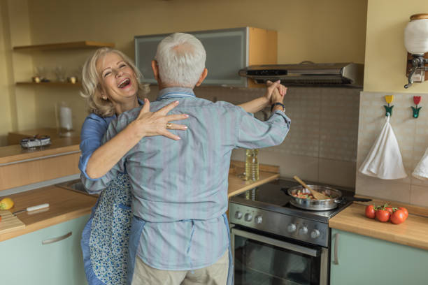 istock Elderly Couple Enjoying in Dance While Cooking at Home. 1326515015