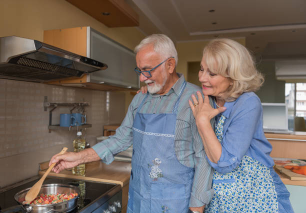 istock Cheerful Elderly Spouses Enjoy Free Time at Home and Cooking a Lunch. 1326515268