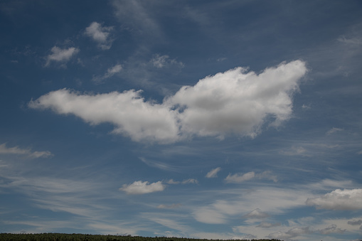 Wispy cirrus and cumulus clouds in Colorado sky over eastern prairie near Colorado Springs, Colorado in western USA. John Morrison - photographer