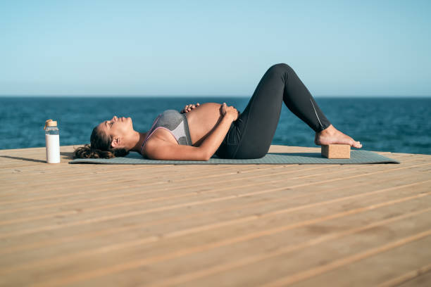 https://media.istockphoto.com/id/1326517184/photo/young-pregnant-woman-doing-prenatal-pilates-exercises-session-next-the-sea-health-lifestyle.jpg?s=612x612&w=0&k=20&c=RG2VJSIyZobqu_VVcda-Vr4noiWgXa21nYv8igaJO8E=