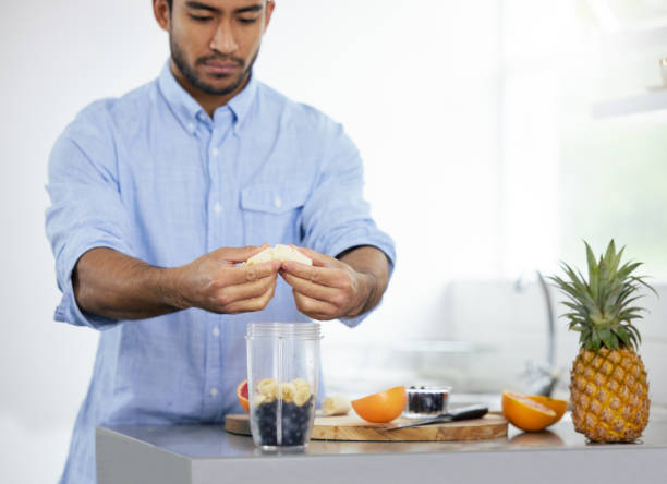 istock Shot of a man making himself a smoothie at home 1326517774