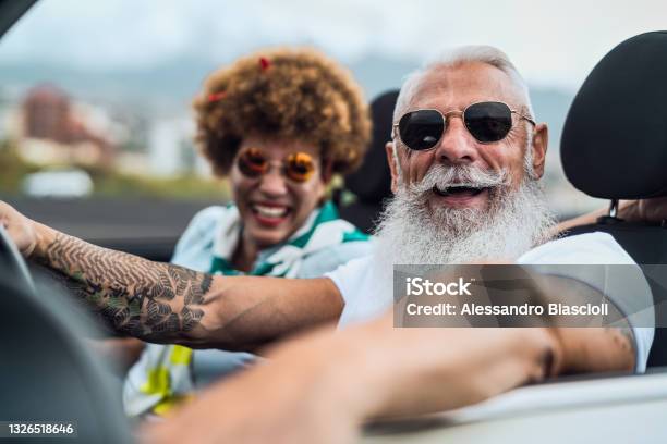 Happy Senior Couple Having Fun Driving On New Convertible Car Mature People Enjoying Time Together During Road Trip Tour Vacation Elderly Lifestyle And Travel Culture Concept Stock Photo - Download Image Now