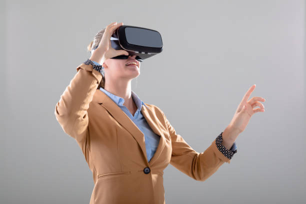 istock Caucasian businesswoman wearing vr headset touching virtual interface, isolated on grey background 1326519677