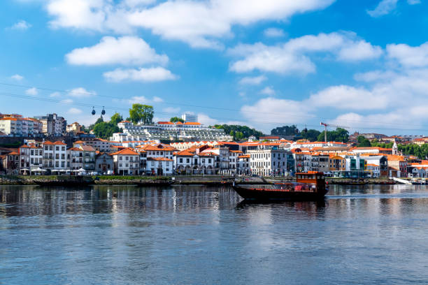 Rabelo Boat Typical Rabelo boat from the Douro River with the view of Vila Nova de Gaia in the background, rabelo boat stock pictures, royalty-free photos & images